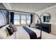 Stylish bedroom with a four-poster bed, elegant dresser, and a large window offering scenic views at 8576 Hotchkiss St, Littleton, CO 80125