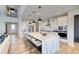 Spacious kitchen boasts a sizable island with seating, stainless steel appliances, and a seamless connection to the living space at 8576 Hotchkiss St, Littleton, CO 80125