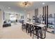 Spacious living room features a large table with seating and a comfortable lounge area, perfect for entertaining guests at 8576 Hotchkiss St, Littleton, CO 80125