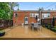 Entertain on the stylish deck with brick home backdrop, complete with outdoor seating, and fenced yard at 1602 Garfield St, Denver, CO 80206