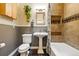 Bathroom features decorative tile, plants, and a pedestal sink at 1602 Garfield St, Denver, CO 80206