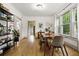 Bright dining room with hardwood floors, large windows, and modern furnishings create a welcoming atmosphere at 1602 Garfield St, Denver, CO 80206