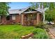 Charming brick home with well-manicured lawn and inviting front porch at 1602 Garfield St, Denver, CO 80206