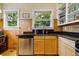 Efficient kitchen space features stainless steel appliances, wood paneling, and natural lighting at 1602 Garfield St, Denver, CO 80206