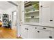 Hallway to living room showing built in cabinet storage on hardwood floors at 1602 Garfield St, Denver, CO 80206