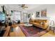 Cozy living room with hardwood floors, stylish furniture, and a ceiling fan at 1602 Garfield St, Denver, CO 80206