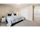 Bright bedroom featuring a king-size bed and sliding door closet at 10610 E 167Th Pl, Brighton, CO 80602