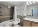 Tiled bathroom featuring a shower-tub combo and updated vanity at 800 N Washington St # 508, Denver, CO 80203