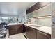 Contemporary kitchen flowing into the living area, featuring dark cabinetry, quartz counters, and stainless steel appliances at 800 N Washington St # 508, Denver, CO 80203