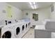 Clean and organized laundry room with multiple modern washing machines at 800 N Washington St # 508, Denver, CO 80203