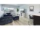 Stylish living area featuring modern seating, a sleek entertainment center, and an open connection to the kitchen at 800 N Washington St # 508, Denver, CO 80203