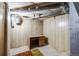 Unfinished basement space with exposed pipes and vintage desk at 310 Jay St, Lakewood, CO 80226