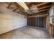 Empty garage space featuring wooden beams, and unfinished walls, offering a versatile area for storage or workshop at 310 Jay St, Lakewood, CO 80226