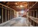 Spacious garage featuring exposed wooden beams, open shelving, and a concrete floor, offering ample storage and workspace at 310 Jay St, Lakewood, CO 80226
