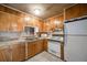 Functional kitchen with light wood cabinets, tile countertops, and standard appliances at 310 Jay St, Lakewood, CO 80226