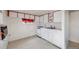 Compact kitchen area with white cabinets and appliances at 310 Jay St, Lakewood, CO 80226