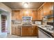 Functional kitchen featuring light wood cabinets, tile countertops, and standard appliances at 310 Jay St, Lakewood, CO 80226