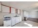 Compact kitchen area with vintage appliances and white cabinets at 310 Jay St, Lakewood, CO 80226