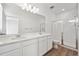 Bathroom with double vanity, shower with glass doors, and neutral decor at 1222 Penner Dr, Erie, CO 80026