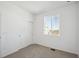This bedroom features neutral carpet, bright white walls, and a closet and large window at 1222 Penner Dr, Erie, CO 80026