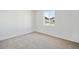 Empty bedroom with neutral carpet and a window offering natural light at 1222 Penner Dr, Erie, CO 80026