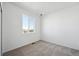 This bedroom features neutral carpet, bright white walls, and a single window at 1222 Penner Dr, Erie, CO 80026