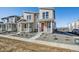Charming home with a red door, landscaped front yard, and a view of the mountains in the background at 1222 Penner Dr, Erie, CO 80026