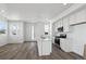 Kitchen with island opens up to the living space, featuring white cabinets and stainless steel appliances at 1222 Penner Dr, Erie, CO 80026