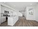 Open kitchen featuring white cabinets, a center island, stainless steel appliances, and wood-look floors at 1222 Penner Dr, Erie, CO 80026