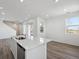 View of kitchen and living room with a quartz countertop island and stainless steel appliances at 1222 Penner Dr, Erie, CO 80026