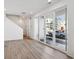 Bright living room with wood-look floors and sliding glass doors that lead to the outside at 1222 Penner Dr, Erie, CO 80026