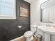 Stylish powder room featuring a window and modern fixtures at 19197 E 64Th Ave, Denver, CO 80249
