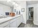 Bathroom featuring double sinks, granite counters, and a closet at 19197 E 64Th Ave, Denver, CO 80249