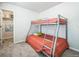 Cozy bedroom features a bunk bed and closet at 19197 E 64Th Ave, Denver, CO 80249