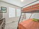 Cozy bedroom with bunk beds, carpeted floor, and natural light streaming through large windows at 19197 E 64Th Ave, Denver, CO 80249