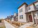 Charming new home exterior featuring a red front door, landscaping, and modern architectural details at 19197 E 64Th Ave, Denver, CO 80249