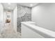 Upstairs hallway featuring neutral tones and stylish wallpaper at 19197 E 64Th Ave, Denver, CO 80249
