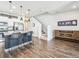 Spacious kitchen with stainless steel appliances, granite countertops, island with seating, adjacent to the staircase at 19197 E 64Th Ave, Denver, CO 80249