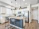 Modern kitchen with stainless steel appliances, granite countertops, and a stylish island with bar stool seating at 19197 E 64Th Ave, Denver, CO 80249