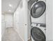 A convenient, stacked, full-sized washer and dryer in a bright laundry area, optimizing space and efficiency at 19197 E 64Th Ave, Denver, CO 80249