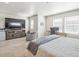 Spacious bedroom featuring a work area, TV, and sitting chair at 19197 E 64Th Ave, Denver, CO 80249