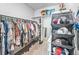 Spacious walk-in closet offering ample storage for clothes and accessories, including shelving and hanging rods at 19197 E 64Th Ave, Denver, CO 80249