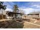 Charming backyard featuring a patio, well-maintained garden beds, and a peaceful outdoor space at 780 Campo St, Denver, CO 80221
