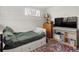 Comfortable bedroom with natural light, featuring a cozy bed and ample storage with a dresser and shelving at 780 Campo St, Denver, CO 80221