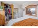 Bright bedroom featuring an orange bed set, closet, and natural light at 780 Campo St, Denver, CO 80221