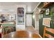 Inviting entryway leading into a home with green walls, a dining space, and adjacent kitchen at 780 Campo St, Denver, CO 80221