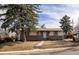 Charming single-story home with stone accents, landscaped front yard, and mature trees in established neighborhood at 780 Campo St, Denver, CO 80221