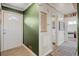 Entryway showcasing a white front door, green walls, and access to other areas of the home at 780 Campo St, Denver, CO 80221