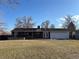 Backyard view of the single-story home, patio, and flat grassy yard at 2357 E Mineral Ave, Centennial, CO 80122
