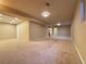 Finished basement with neutral carpeting, recessed lights, and multiple access points at 2357 E Mineral Ave, Centennial, CO 80122